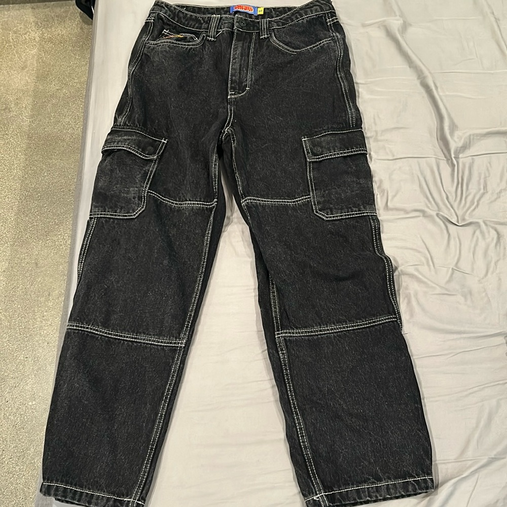 Black washed cargo pants with white stitch outlining.